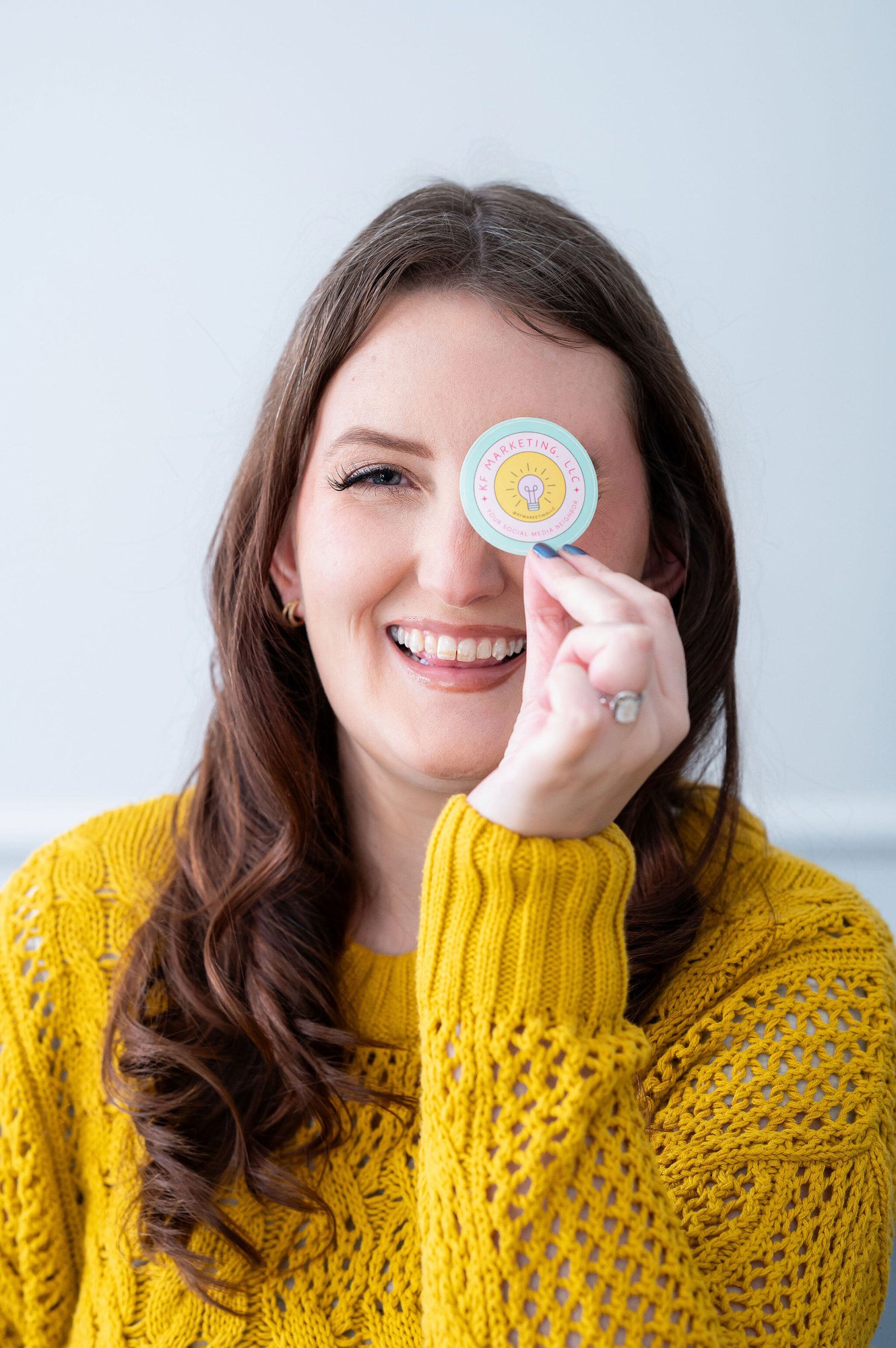 KF holding a sticker by her eye.