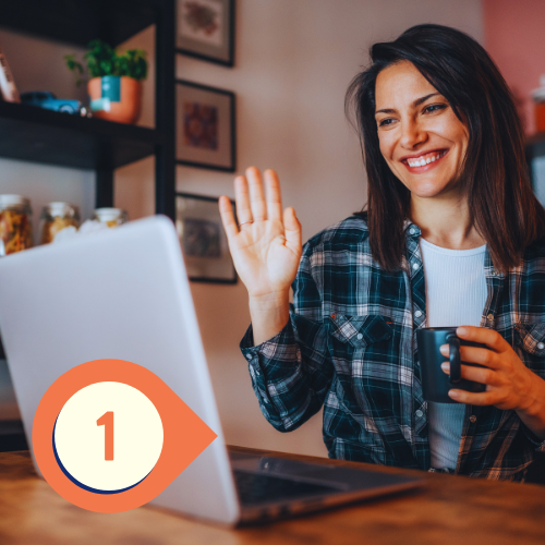 a person is sitting in front of a laptop and waving